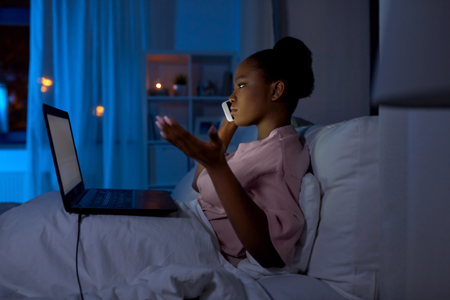 Women in Bed on Phone at Night 