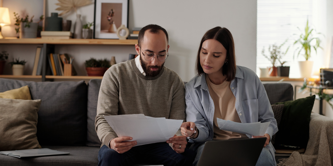 Man and women looking at paperwork and computer