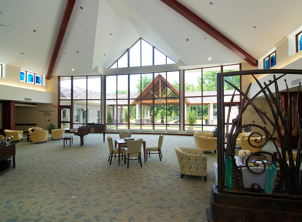 Open indoor gathering space with large windows and seating areas.