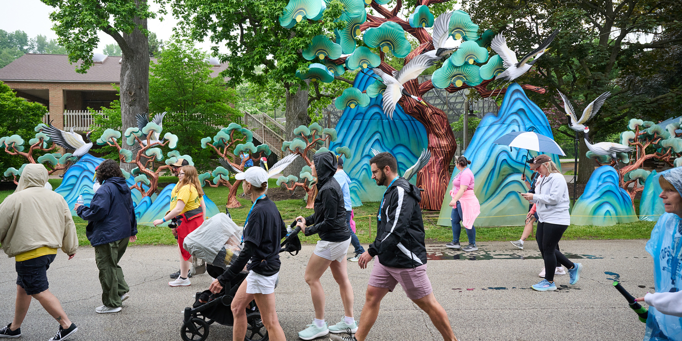 People walking past colorful outdoor art installation