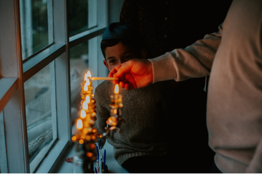 family lighting menorah 