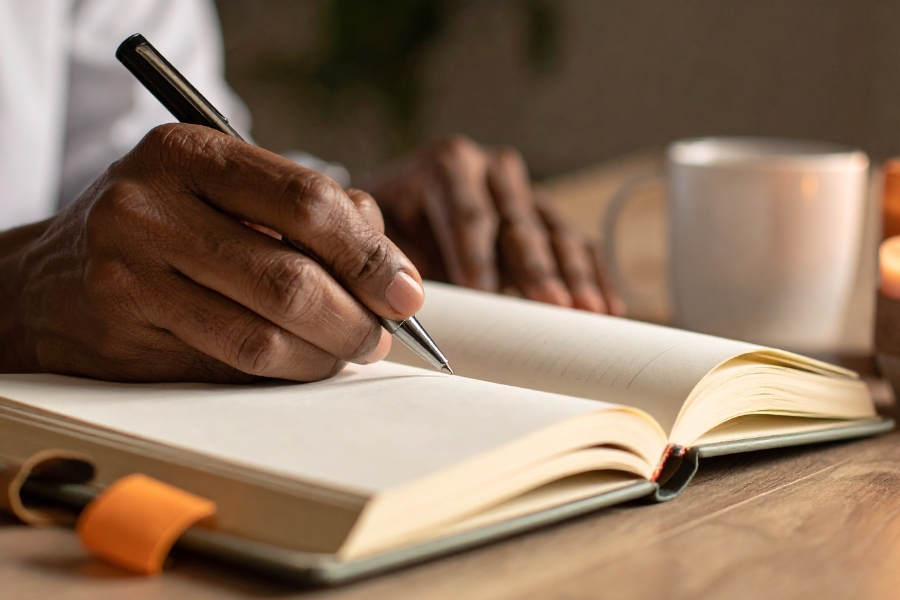 person writing in journal