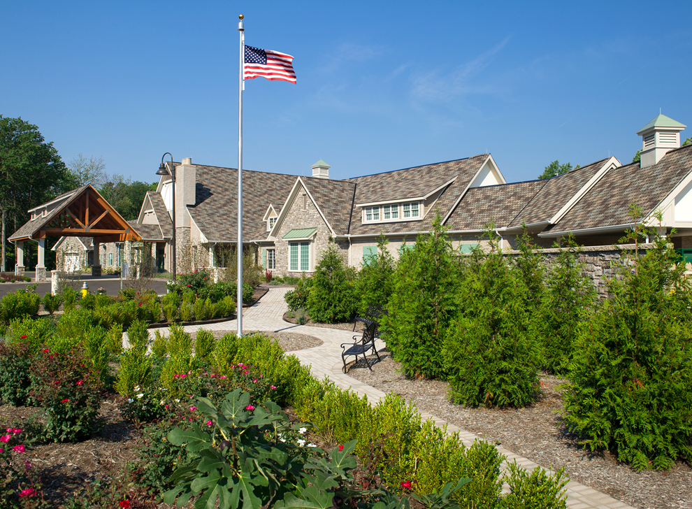 Large building with landscaped outdoor area and clear blue sky