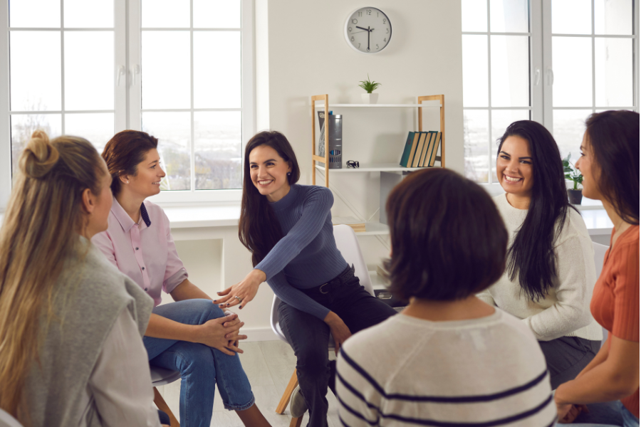 Women sitting around happy
