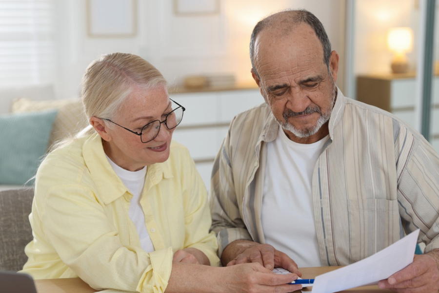Man and women looking at paperwork and computer