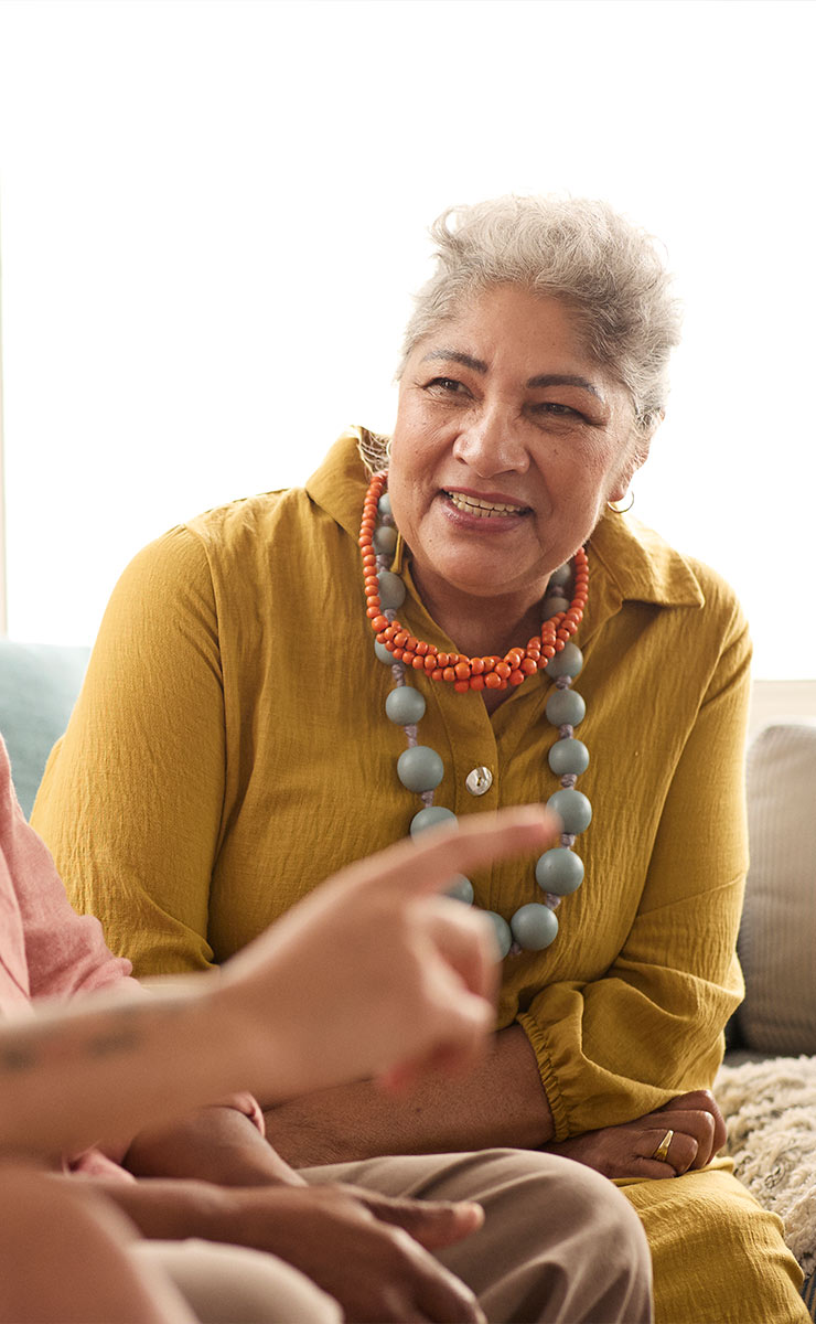 Older woman engaged in a group conversation or support session