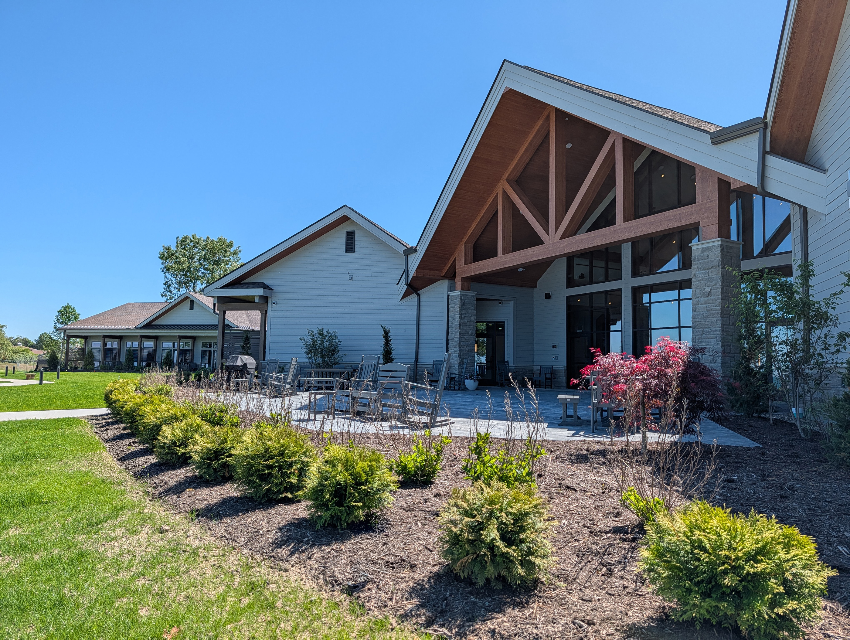 Care Center Cleveland with a large patio surrounded by bushes and trees