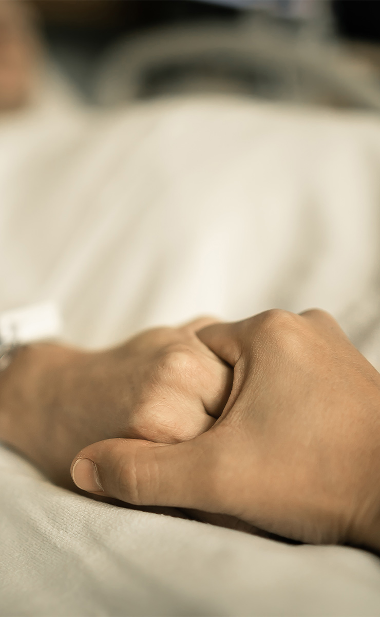 Hand-holding moment offering comfort and emotional support.
