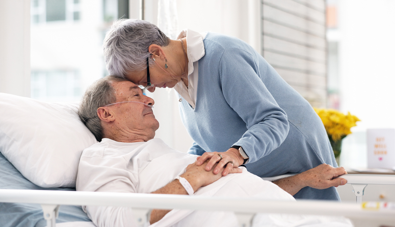 Two people holding hands in a healthcare room