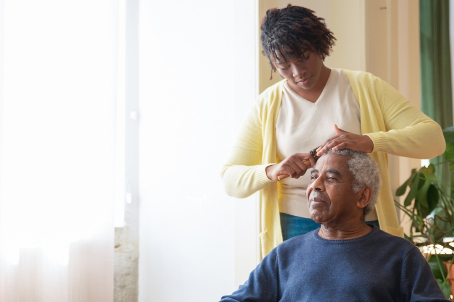 Woman brushing father hair 