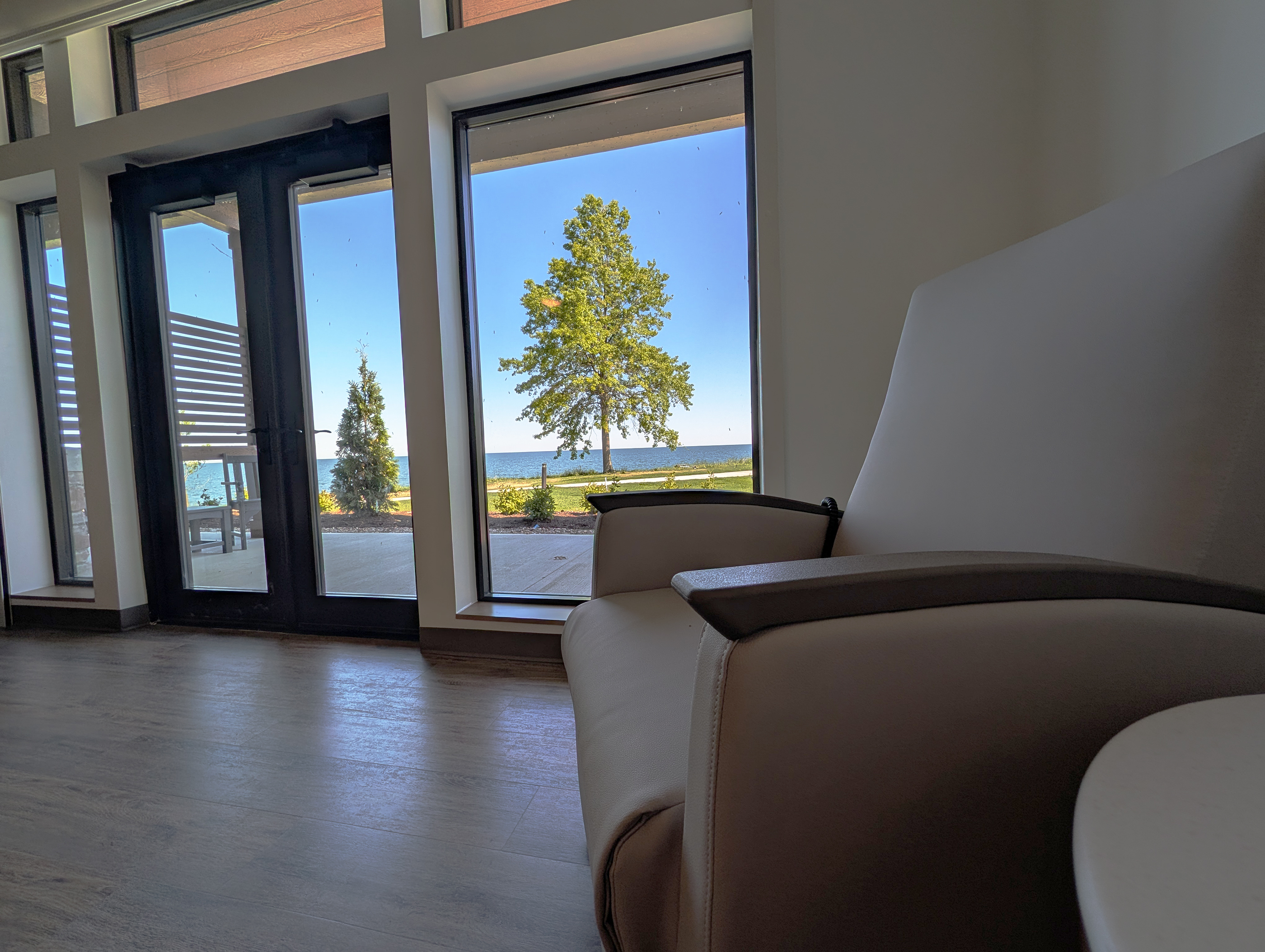 Cleveland Care Center room with chair facing large windows that have a view of Lake Erie